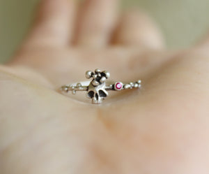 Thin sugar skull ring in sterling silver with hot pink zircon