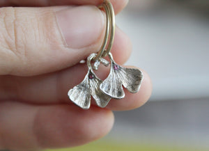 Sterling silver ginkgo leaf hoop earrings with pink zircon