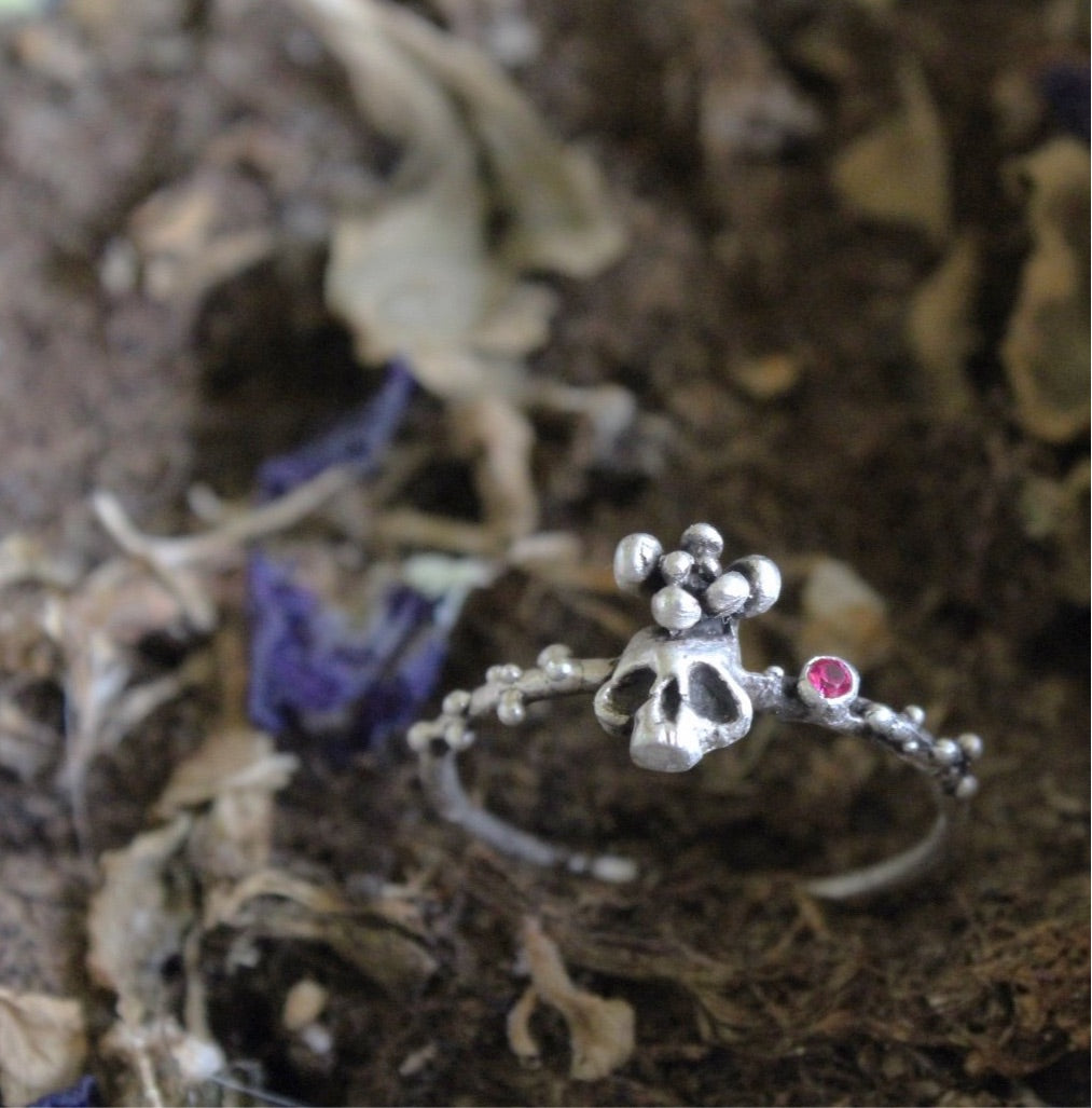 Thin sugar skull ring in sterling silver with hot pink zircon