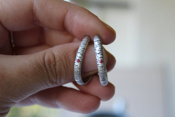 Sterling silver textured hoops with pink cubic zirconia