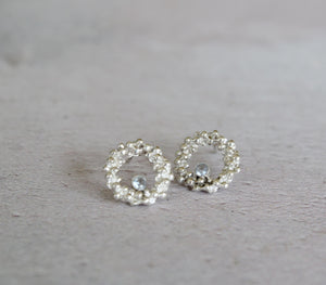 Tiny open circle stud earrings with aquamarine